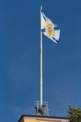 Saint Andrew Andreevskyflag (Ensign of the Russian Navy) on a flagpole waving the roof of the...
