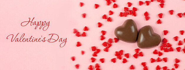 Valentine's day concept with red hearts on pink background. Top view. Copy space.
