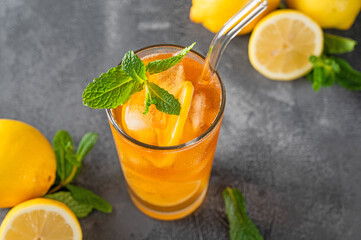 Ice tea or long island cocktail with slice of lemon on a dark background. copy space, selective focus