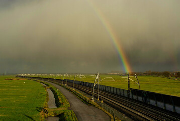 Rainbow above an empty railroad track near Sliedrecht