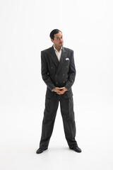 Handsome man dressed elegant classic suit standing on white background with inquiring look at camera