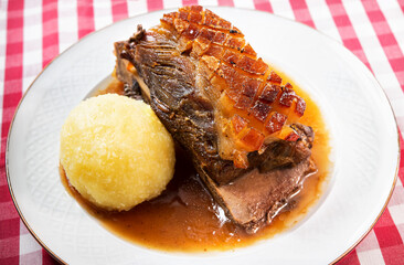 Appetizing Bavarian (Franconian) speciality. Roast pork shoulder with dumplings and dark beer sauce
