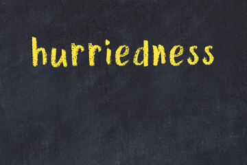 College chalk desk with the word hurriedness written on in