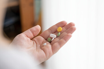 hands holding a pill