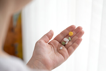 hands holding a pill