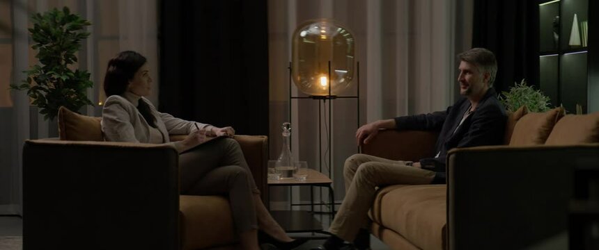 40s Caucasian male having an appointment with his psychologist in the evening. Shot with 2x anamorphic lens