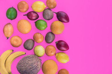 Obraz na płótnie Canvas Fresh fruitage on pink background. Coconut, orange, limes