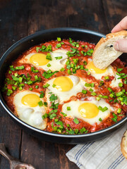Shakshuka in a Frying Pan. Eggs Poached in Spicy Tomato Pepper Sauce.