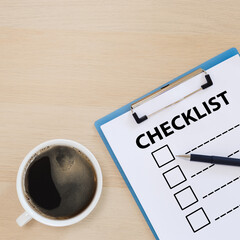 checklist box on clipboard with pen and coffee cup on wooden table. check choice answer test. checklist information writing.