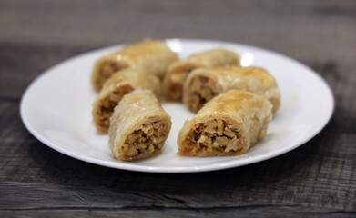 A white plate full of freshly baked Lebanese baklawa.