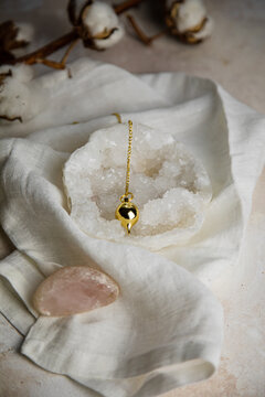 Divination pendulum on a quartz geod