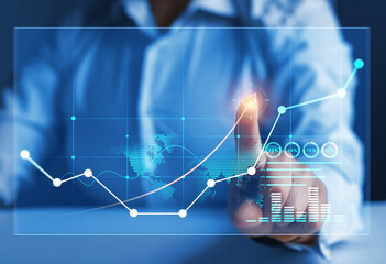 Financial stock exchange.
Businesswoman looking at increase revenue chart on a digital virtual screen.Business development to success, profit and growing growth plan.Global business investment.