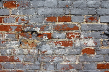 Old brick wall made of red ceramic bricks horizontal rows, covered with gray cement loft style background texture