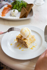 Fresh apple strudel pie served with vanilla ice cream