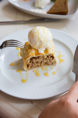Fresh apple strudel pie served with vanilla ice cream
