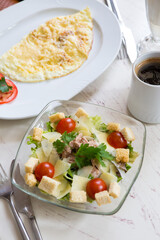 Caesar salad with egg omlette served for breakfast