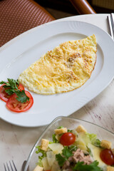 Caesar salad with egg omlette served for breakfast