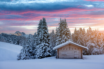Picturesque landscape with small wooden log cabin on meadow Alpe di Siusi on sunrise time. Seiser...