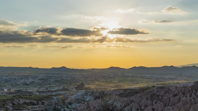 4k stock video time lapse of amazing scenic spring or summer sunset mountainous landscape. Natural scenery background of peaceful moving heaven, sun circle rolling down behind clouds