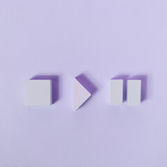 Monochromatic purple composition with wooden shapes of stop, play and pause symbols. Flat lay...