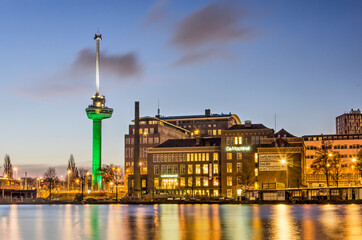 Obraz premium Rotterdam, The Netherlands, January 17, 2022: view across Coolhaven harbour towards the historic Machinist building and Euromast observation tower during the blue hour on a winter morning