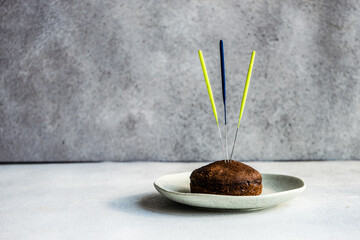 Chocolate fondant cake with three unlit sparklers