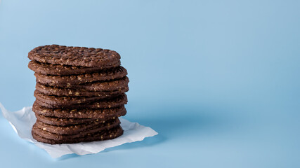 Stack of Delicious Chocolate Cookies with Oatmeal on Blue Background Copy Space Tasty Homemade Cookies