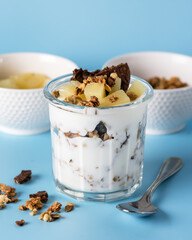 Healthy Dessert of Natural Yogurt Cookies with Oatmeal and Pineapple Served in Glasses Portion Desert in Glass Copy space Blue Packground
