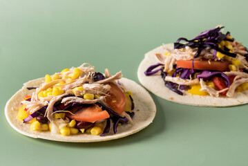 Tacos with Vegetables Corn and Chicken on Green Background Horizontal