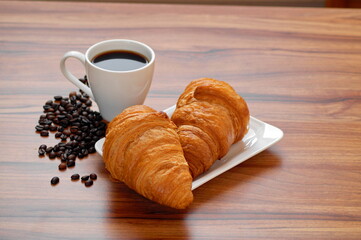 A cup of coffee and two croissants is a good start to the day. Continental breakfast