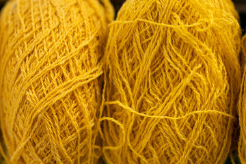 skeins of yellow yarn in a detailed form