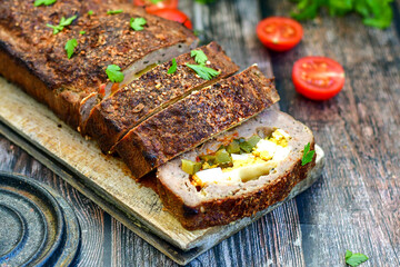 Home made baked  delicious  German meatloaf (Falscher Hase or Hackbraten) is a traditional pork and beef meat loaf bound with boiled eggs and cucumbers