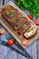 Home made baked  delicious  German meatloaf (Falscher Hase or Hackbraten) is a traditional pork and beef meat loaf bound with boiled eggs and cucumbers