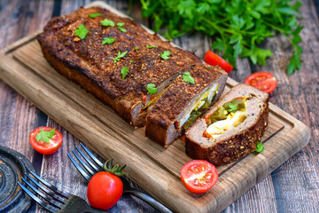 Home made baked  delicious  German meatloaf (Falscher Hase or Hackbraten) is a traditional pork and beef meat loaf bound with boiled eggs and cucumbers