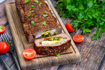 Home made baked  delicious  German meatloaf (Falscher Hase or Hackbraten) is a traditional pork and beef meat loaf bound with boiled eggs and cucumbers