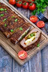 Home made baked  delicious  German meatloaf (Falscher Hase or Hackbraten) is a traditional pork and beef meat loaf bound with boiled eggs and cucumbers