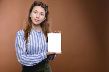 Studio portrait of caucasian office woman with electronic tablet. The cut screen of the device. Mobile Application Presentation