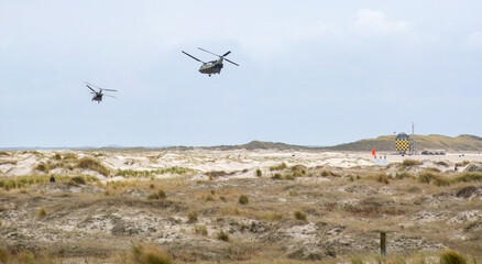 Chinook helicopters flying over the beach