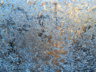 Winter frozen window covered with ice crystals
