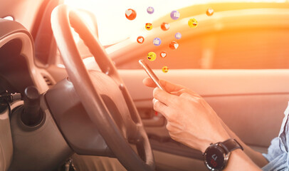 Social media concept, a man using a smartphone in his car