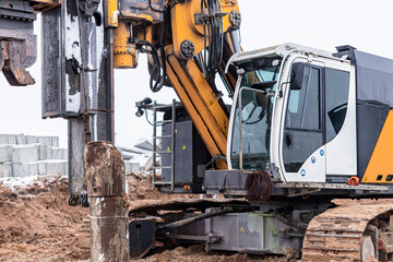 Fototapeta premium A powerful drilling rig for peeling at a construction site. Operation of the drilling rig in northern conditions. Pile foundations. Bored piles.