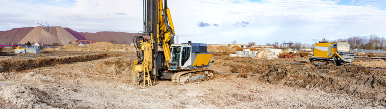 A powerful drilling rig for peeling at a construction site. Operation of the drilling rig in northern conditions. Pile foundations. Bored piles. Pagoramic view. Banner format.