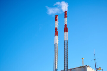 Pipes of a small gas power plant in the blue sky