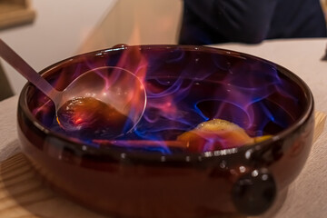 Making burnt rum cocktail from Catalonia, typically known as cremat