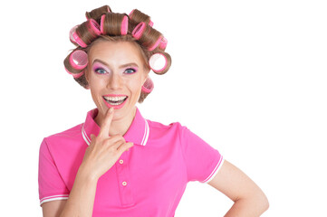 Beautiful woman with hair curlers in studio