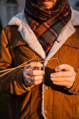 Man holding dowsing rod outside