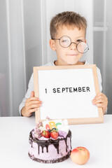 Banner of Funny adorable little boy in glasses with letter board. Education. 1 September. Back or First to school. Copy space