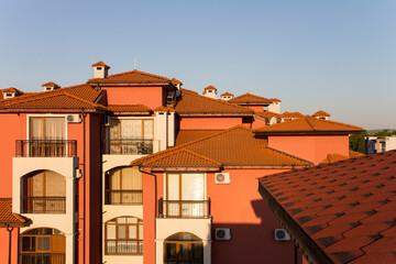 Different types of tiled roofs: flexible tiles and ceramic. The roof of a large residential building on the Black Sea coast. Properties in Bulgaria near the sea for sale and rent.