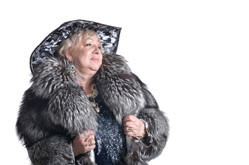Portrait of senior woman wearing black hat and fur coat on white background