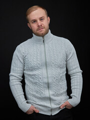 Obraz premium vertical portrait blond man on a dark background, in a jacket